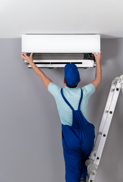 Certified AC technician repairing wall-mounted air conditioner in Dubai